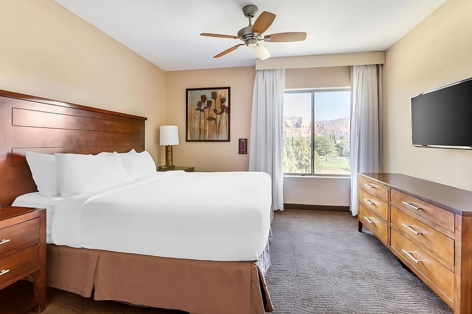 Stretch out in a serene bedroom with view and big TV.