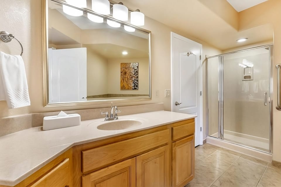 Rinse off in a roomy glass shower with generous counter space.