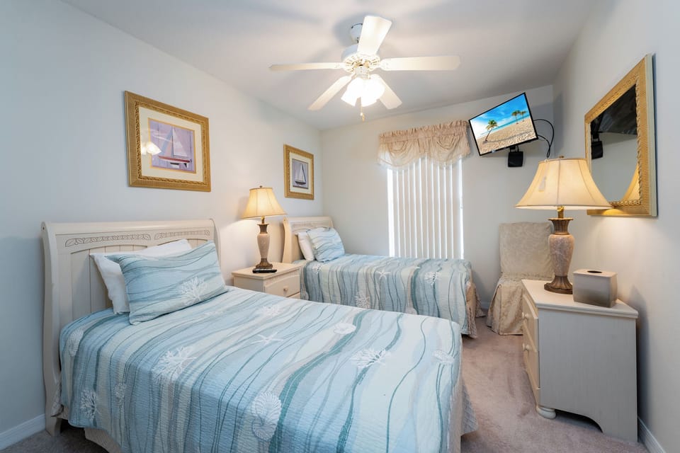 Bedroom 4 with 2 twin beds showing TV
