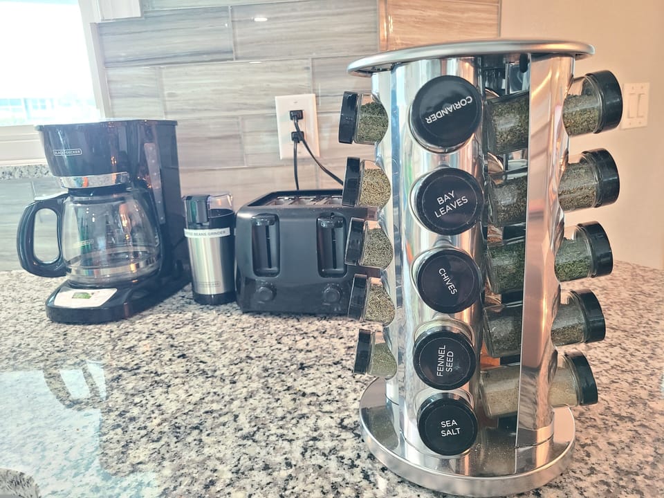 Spices, coffee, toaster, air fryer, coffee grinder, lots of appliances 