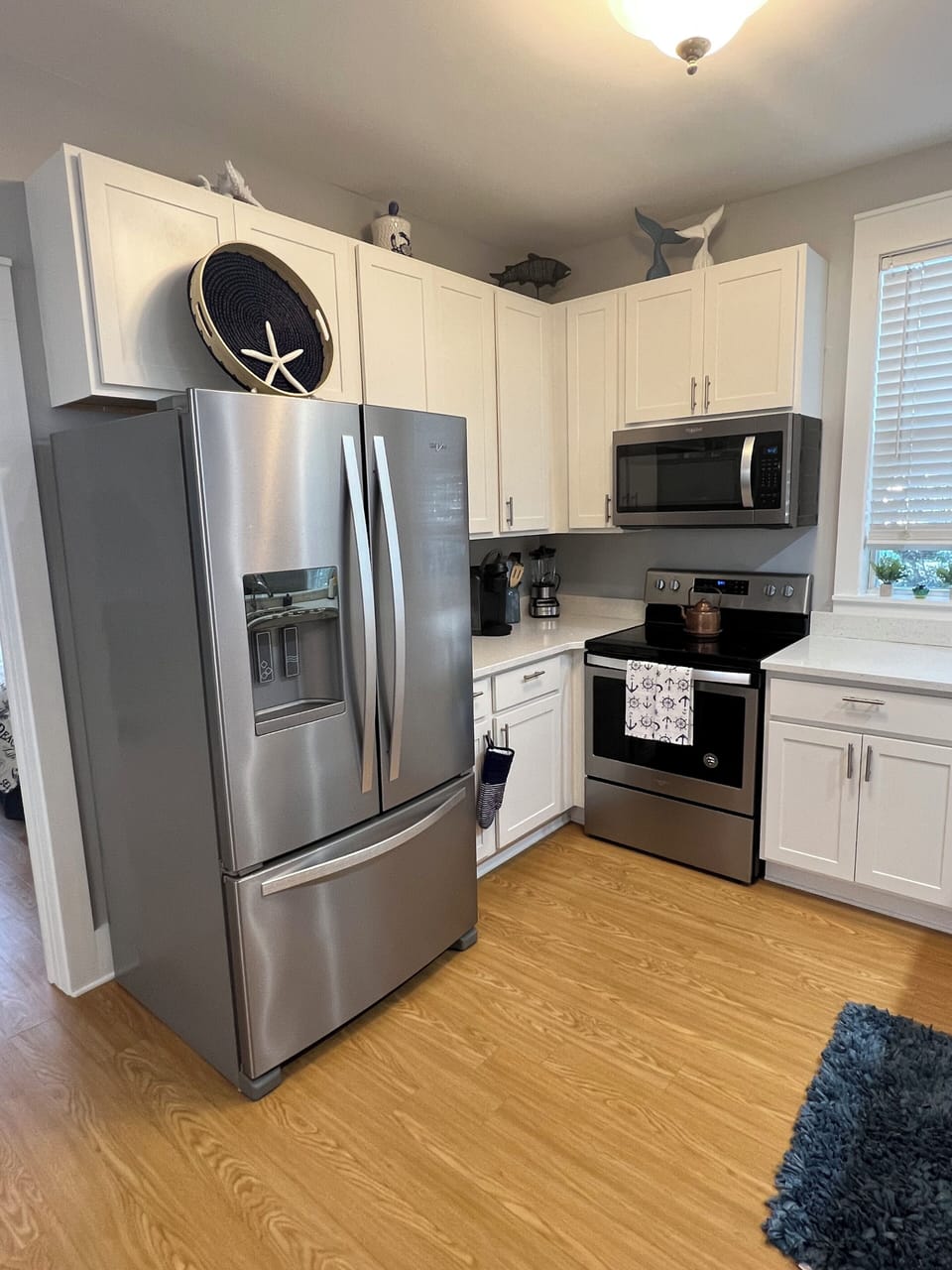 SS appliances include large refrigerator, stove, and microwave 