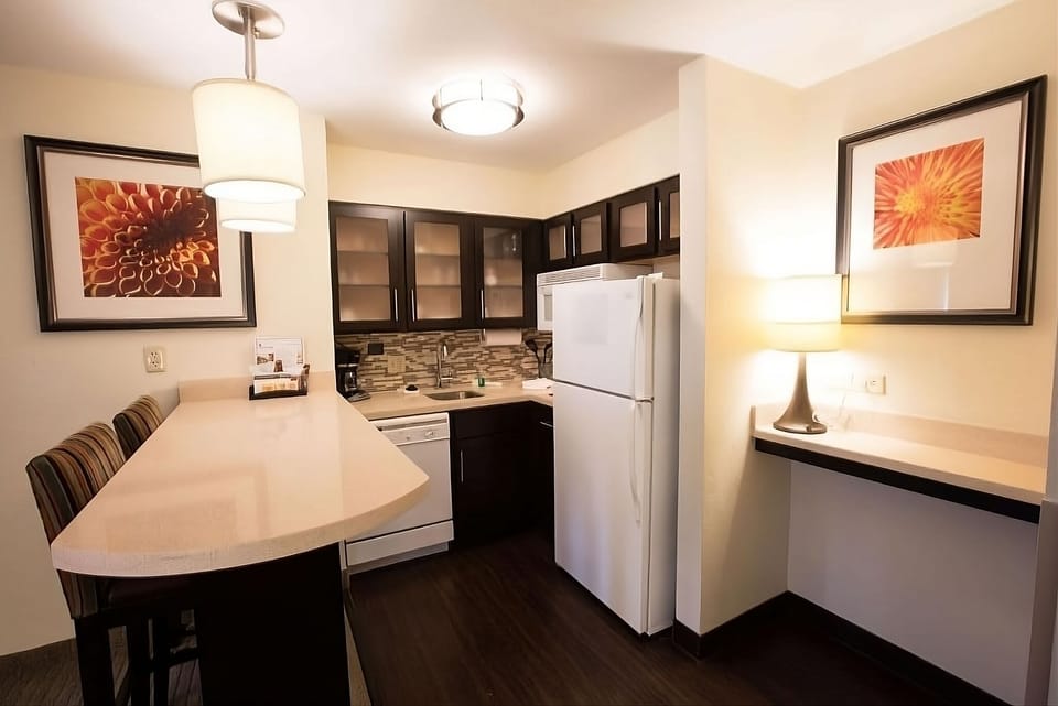 Cook and gather around the breakfast bar under warm lights.