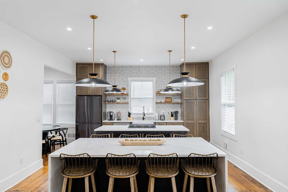 Fully stocked brand new luxury designer kitchen with two islands, and black stainless steel appliances. it'll be a joy to cook for the family in here!