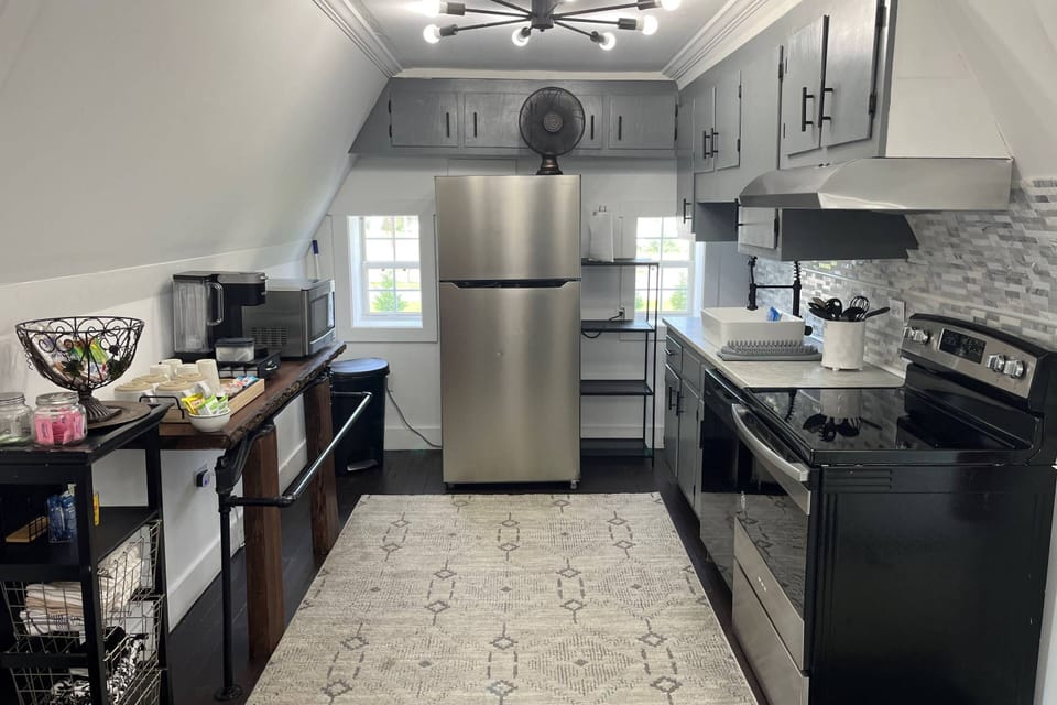 Fully stocked kitchen has ample dishes, glasses, silverware, bowls, pots and pans for quick food on the run or full meals.