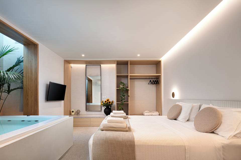 The bedroom features a 43 smart TV, a spacious closet, A/C, and an en-suite bathroom with a refreshing shower cabin.