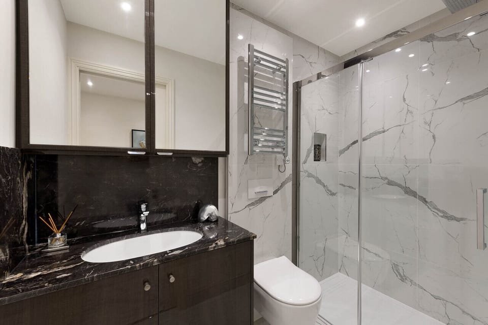 Bathroom — double shower with quality towels, hairdryer, shower amenities, and underfloor heating throughout