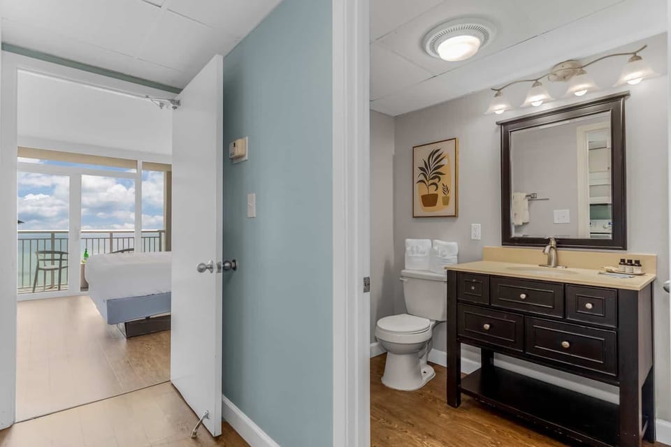 Conveniently designed ensuite with a stylish vanity and a calming ambiance. Enjoy the seamless connection to your cozy bedroom with stunning ocean views just steps away.
