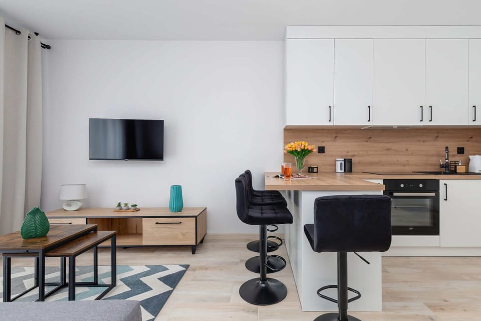 An open-plan living area blending the kitchen, dining, and lounging spaces harmoniously.

