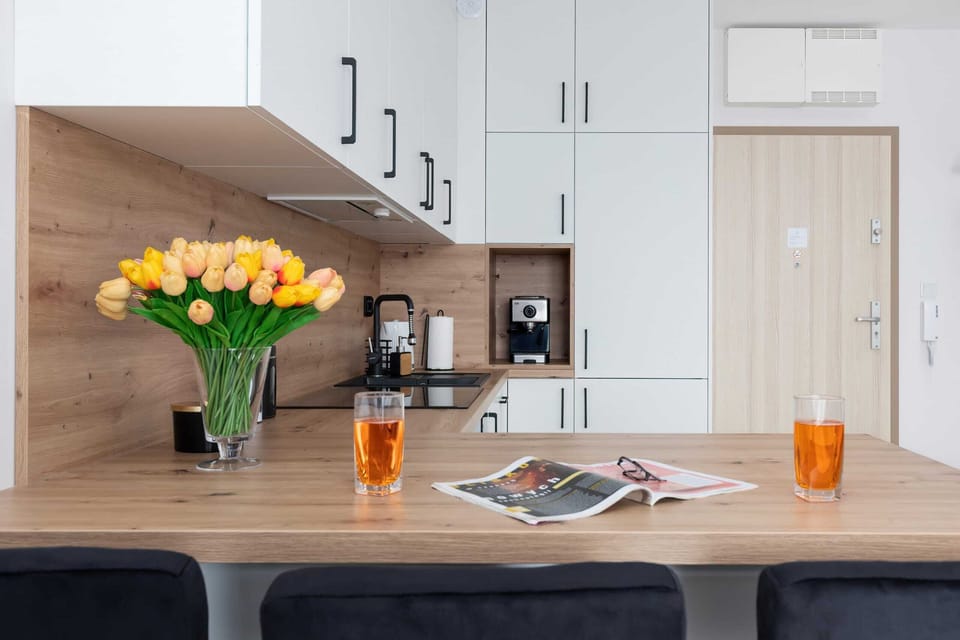 A kitchen table adorned with fresh flowers and orange juice, creating a welcoming vibe.

