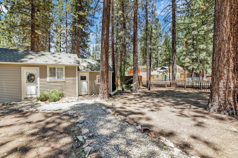 Spacious backyard featuring an outdoor picnic table and plenty of open space perfect for relaxing, playing, and enjoying time outdoors with family and friends.