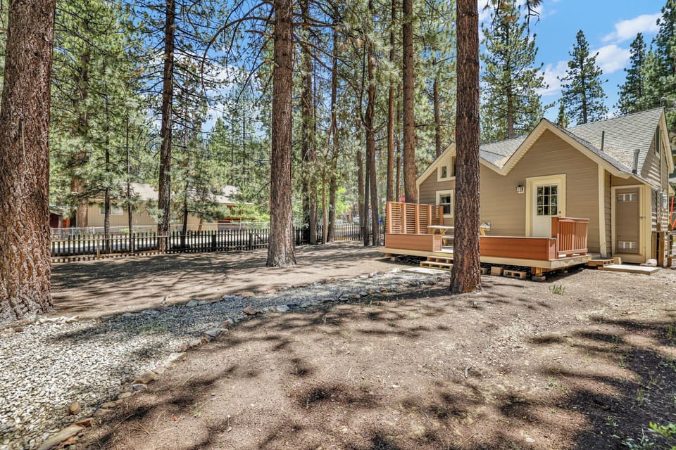 Spacious backyard featuring an outdoor picnic table and plenty of open space perfect for relaxing, playing, and enjoying time outdoors with family and friends.