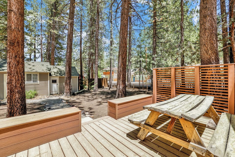 Spacious backyard featuring an outdoor picnic table and plenty of open space perfect for relaxing, playing, and enjoying time outdoors with family and friends.