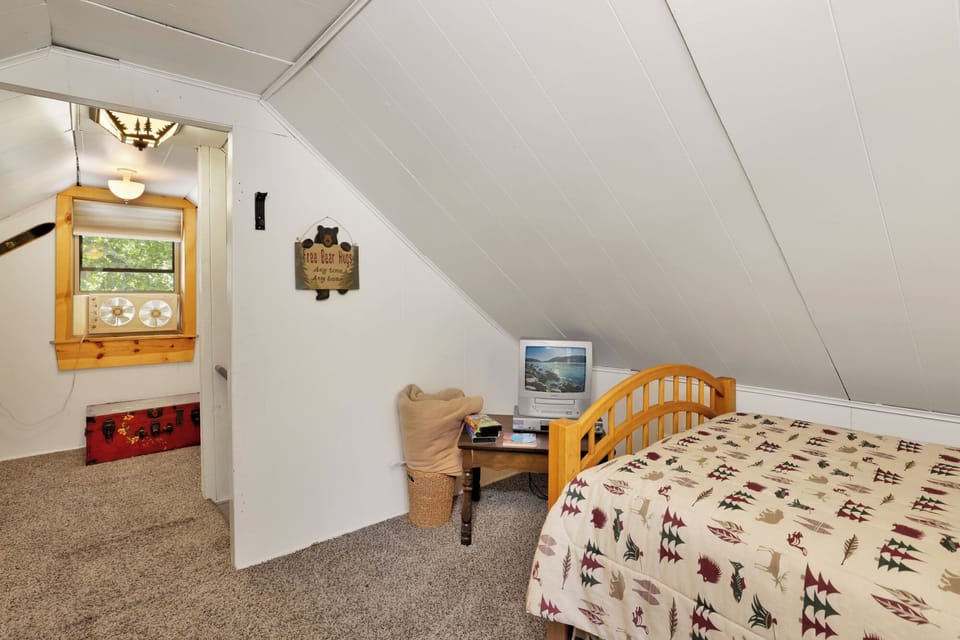 Peaceful cabin bedroom with plush bedding, and beautiful views—ideal for restful nights, cozy mornings, and a relaxing mountain escape.