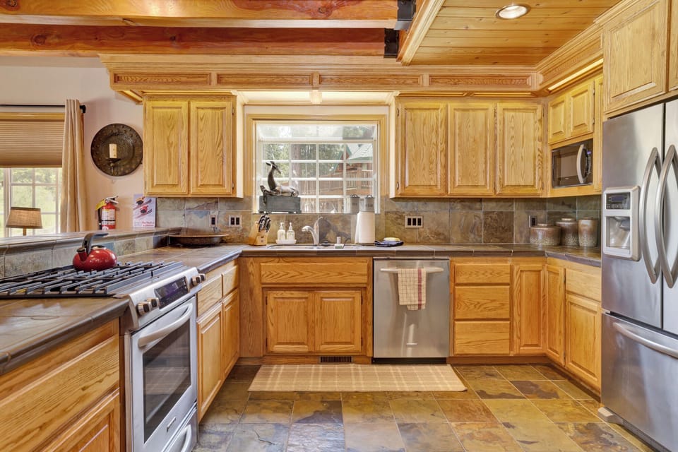 Fully equipped cabin kitchen with ample cabinetry, stove, fridge, and coffee maker—perfect for cooking meals, morning coffee, and feeling right at home on your stay.