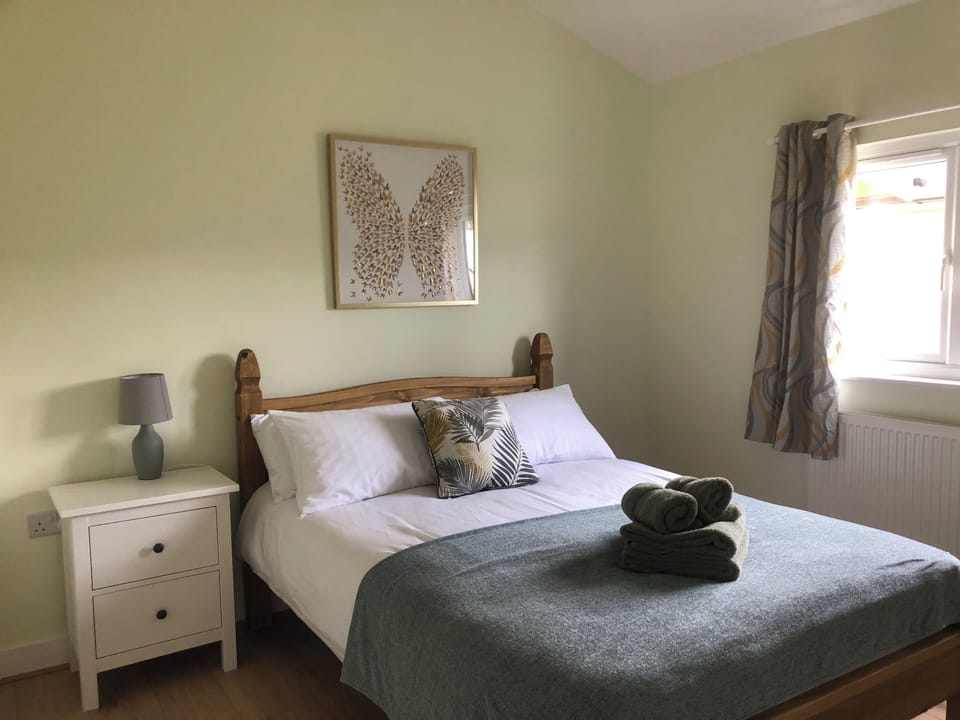 Double bedroom with hanging space and chest of drawers. 