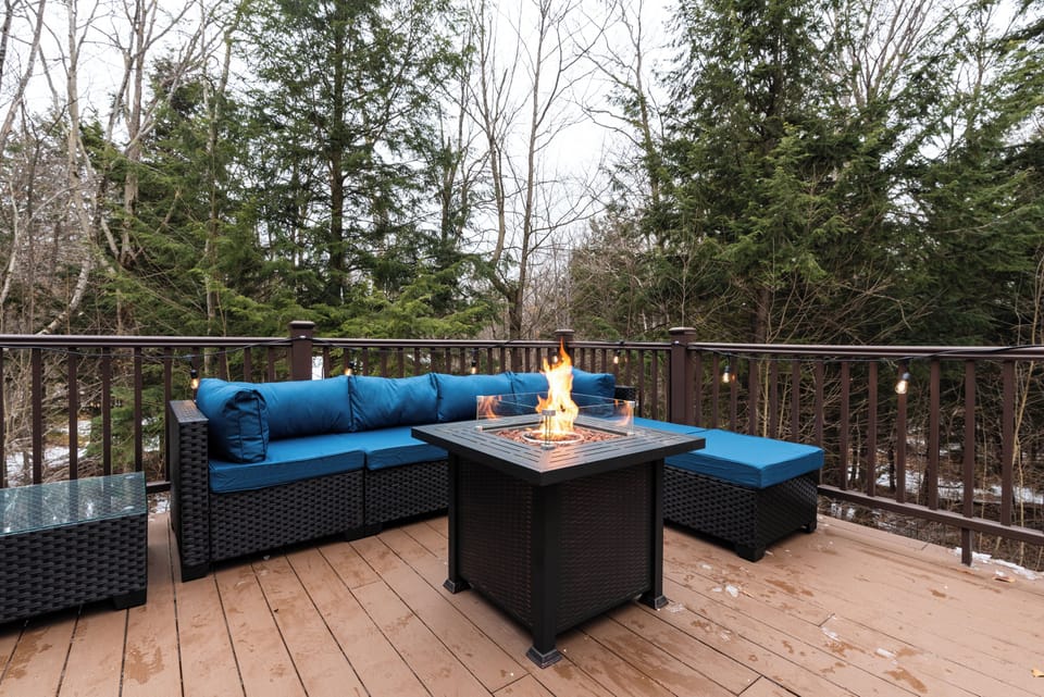 Expansive deck with fire pit table, outdoor seating, Weber grill, and hot tub!