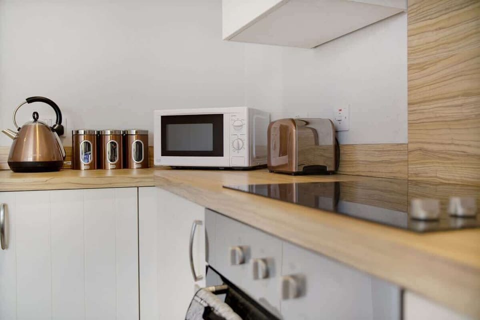 Kitchen equipped with all essentials, including a washer & dryer, oven, fridge and full cookware set.