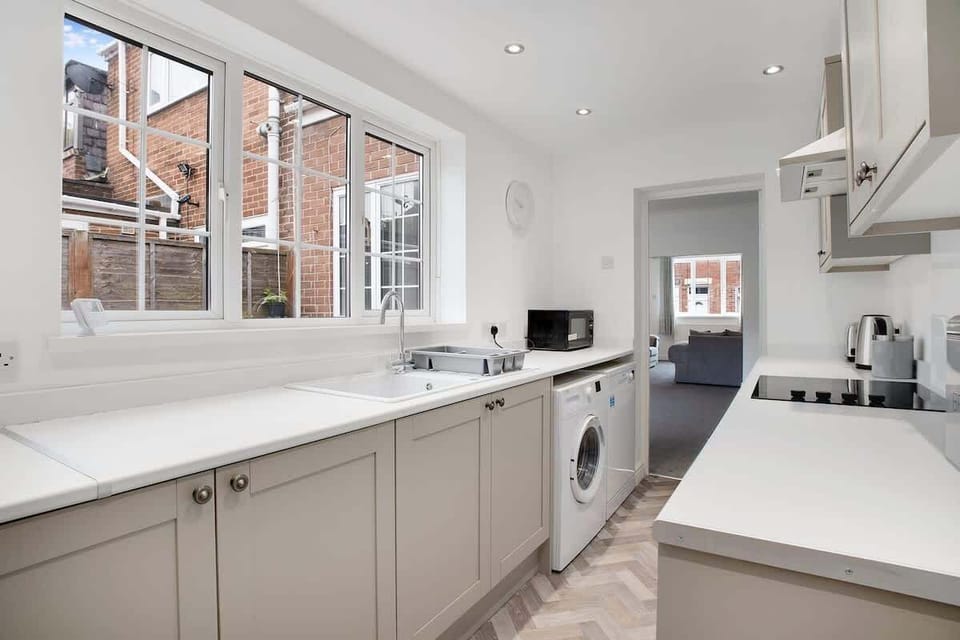 Kitchen equipped with all essentials, including a washer & dryer, oven, fridge and full cookware set.