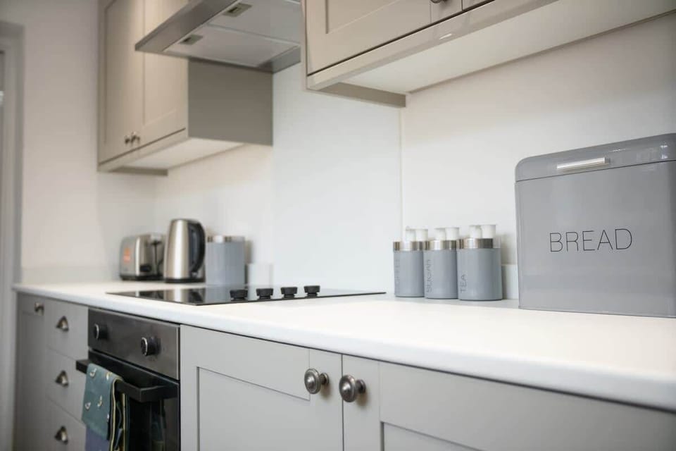 Kitchen equipped with all essentials, including a washer & dryer, oven, fridge and full cookware set.