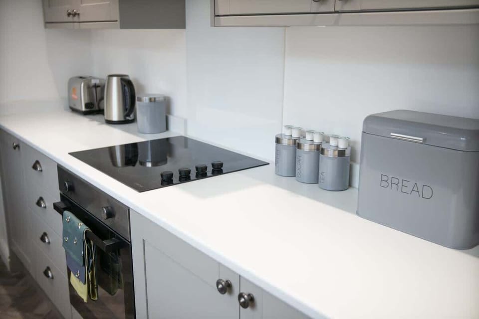 Kitchen equipped with all essentials, including a washer & dryer, oven, fridge and full cookware set.