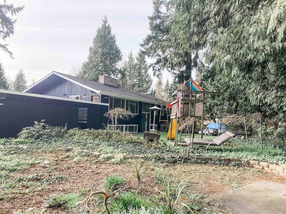 Freshly painted outdoors with trampoline and play house.
