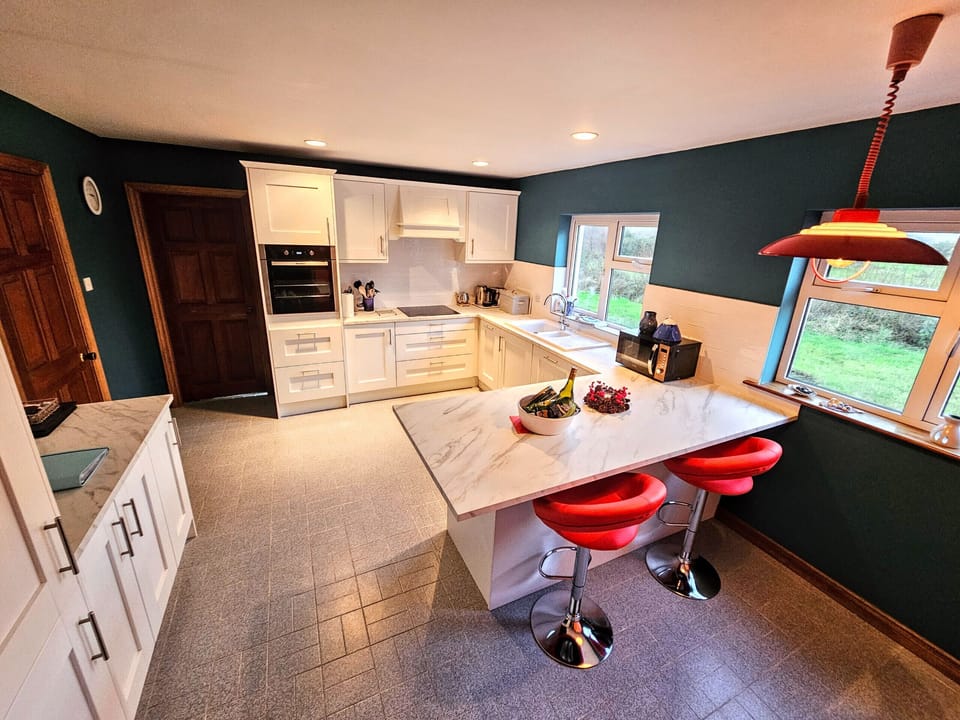 Lark Rise Holiday Home Glenbeigh. Modern Kitchen, high stools with counter.