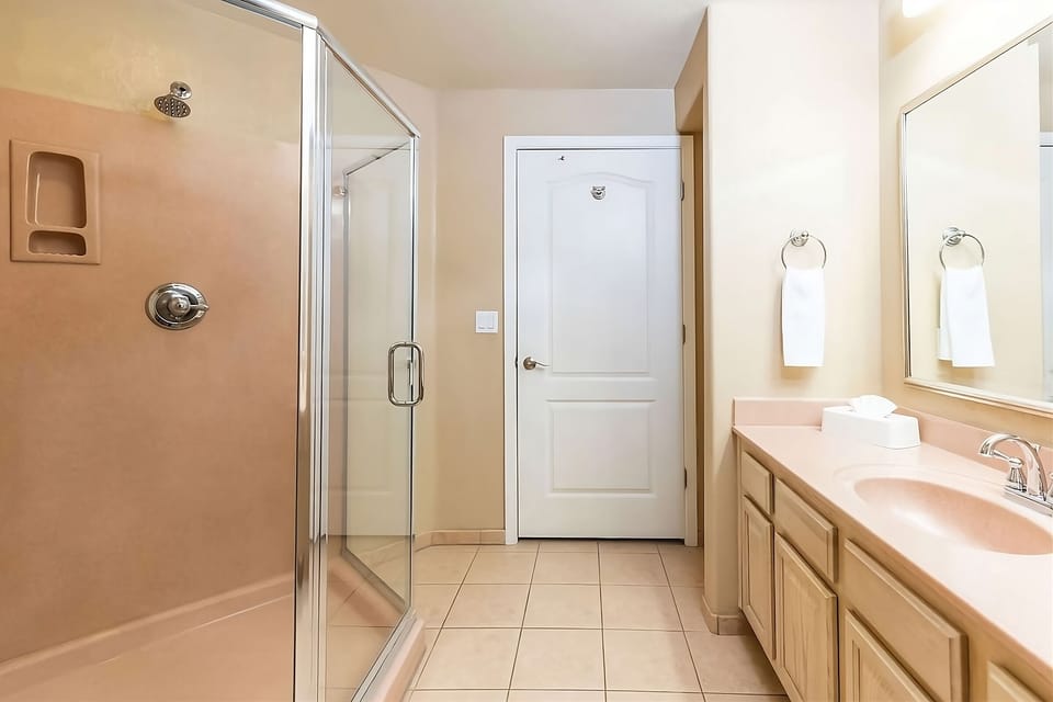 Refresh easily with a bright vanity and glass shower.