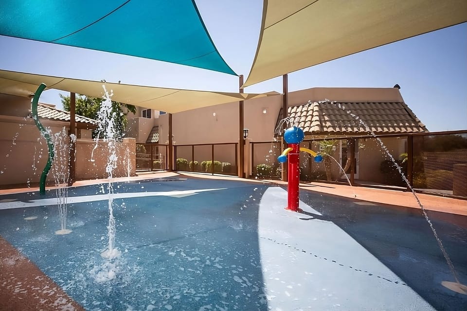 Let kids giggle through playful splash sprays in cooling shade.