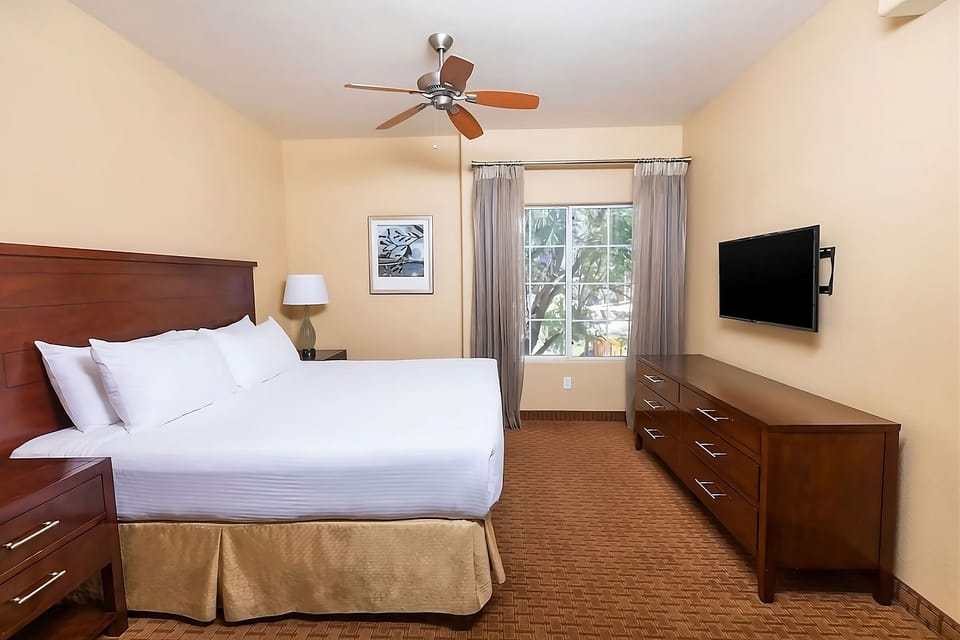 Stretch out with a wall-mounted TV and sunny window views.