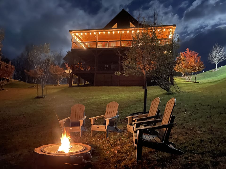 Fire pit in backyard with view of cabin