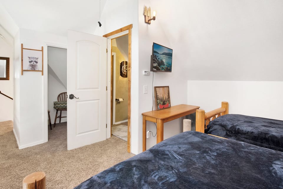 Peaceful cabin bedroom with plush bedding, and beautiful views—ideal for restful nights, cozy mornings, and a relaxing mountain escape.