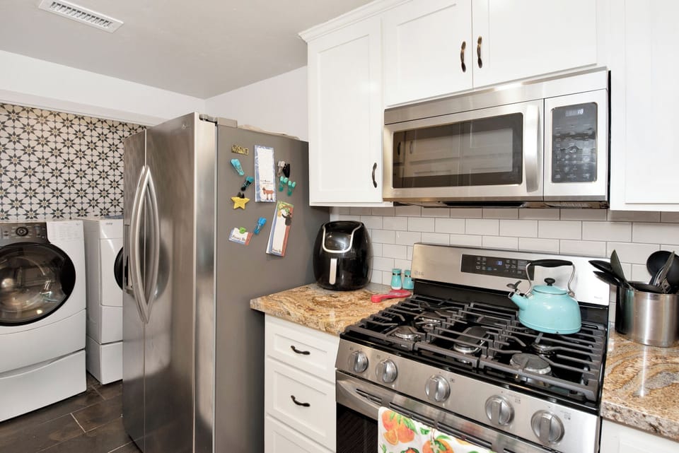Fully equipped cabin kitchen with ample cabinetry, stove, fridge, and coffee maker—perfect for cooking meals, morning coffee, and feeling right at home on your stay.