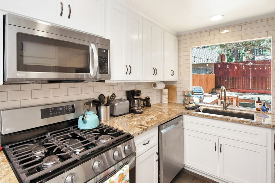 Fully equipped cabin kitchen with ample cabinetry, stove, fridge, and coffee maker—perfect for cooking meals, morning coffee, and feeling right at home on your stay.