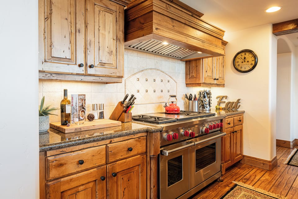 Stainless steel Wolf 6-burner gas range with double ovens.