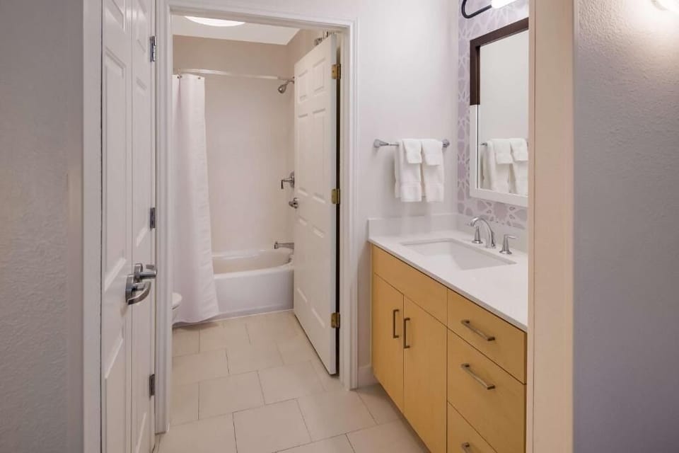 Refresh in a spotless bathroom with bright vanity lighting.