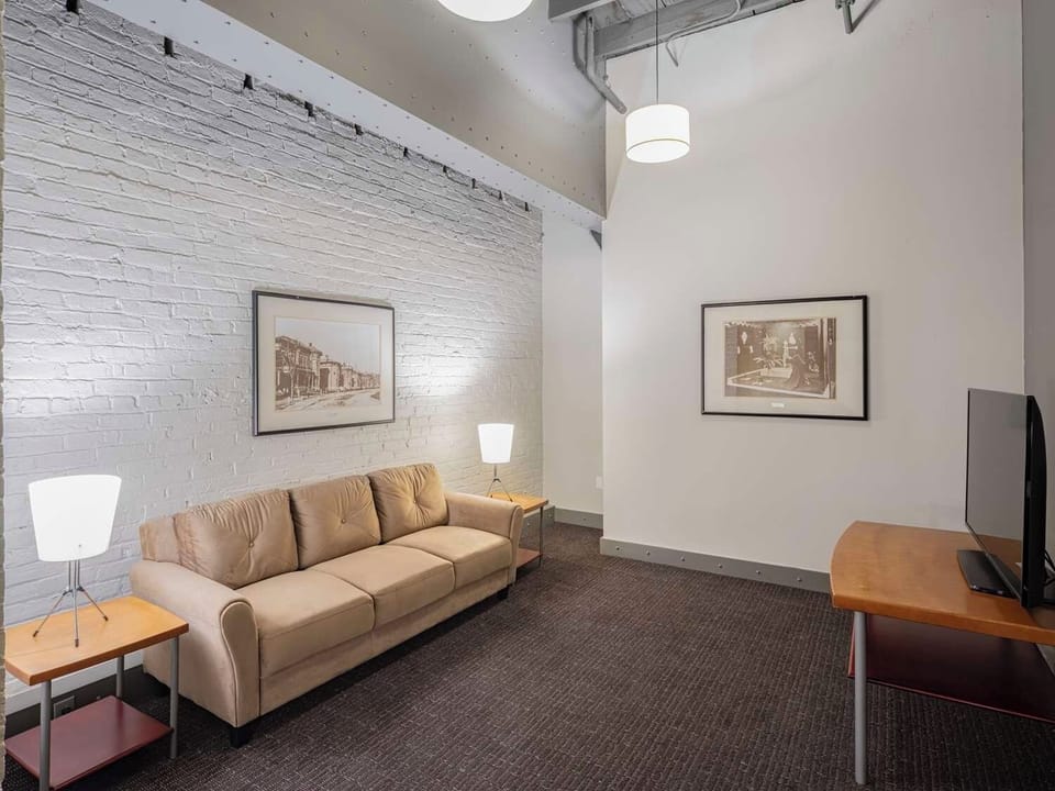 Relax on the sofa beneath high ceilings and soft lighting.
