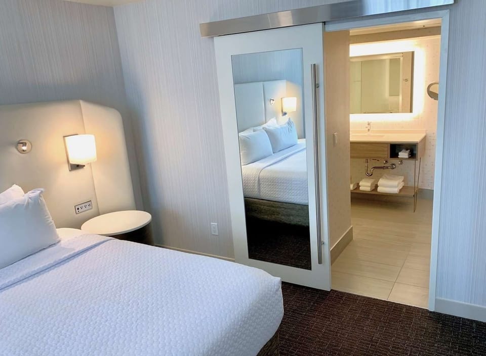 Enjoy easy suite flow from bed to bright, modern vanity