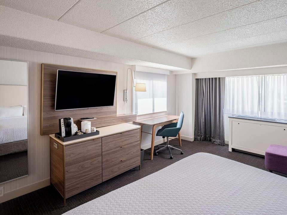 Unwind in a bright room with desk and streaming-ready TV.