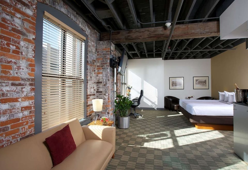 Unwind in a sunlit loft bedroom with exposed brick charm