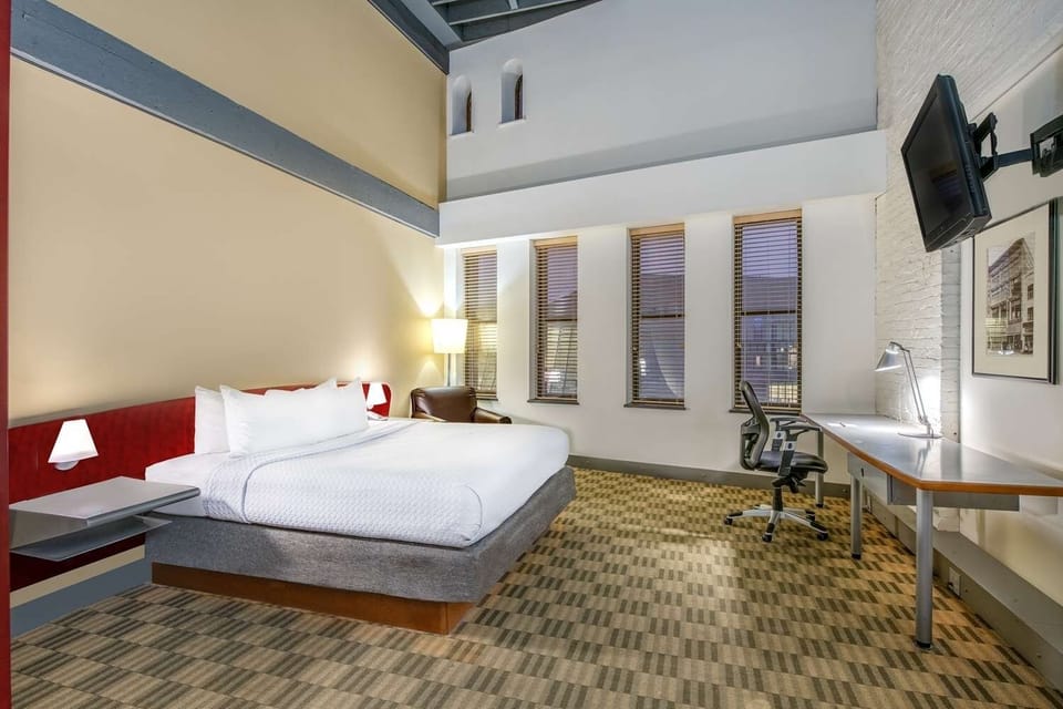 Stretch out on a plush bed beside a dedicated work area
