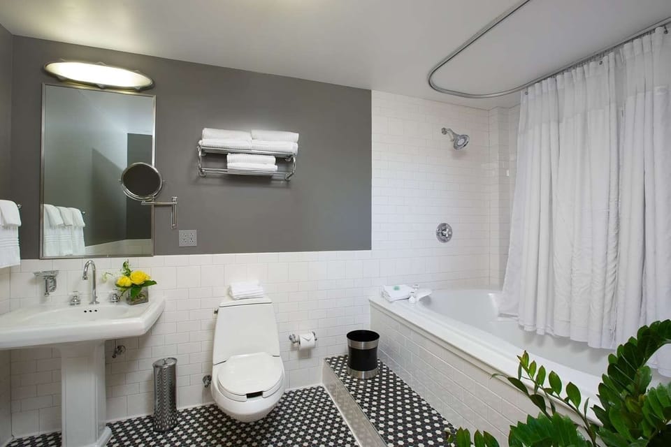 Refresh with a deep tub, bright tile, and fluffy towels.