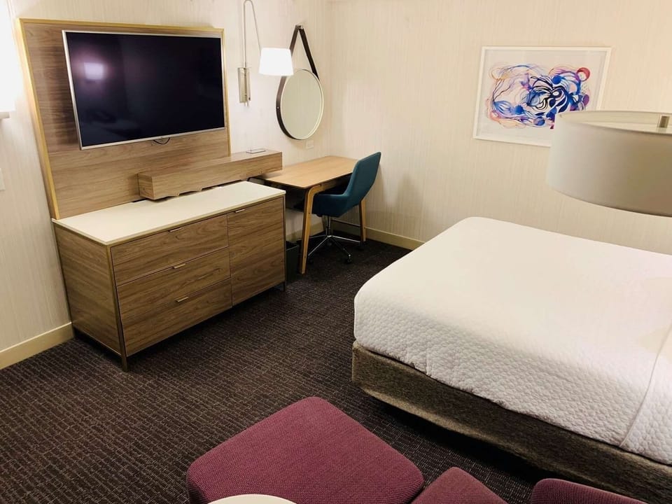 Recharge in a crisp, comfortable room with warm lighting.