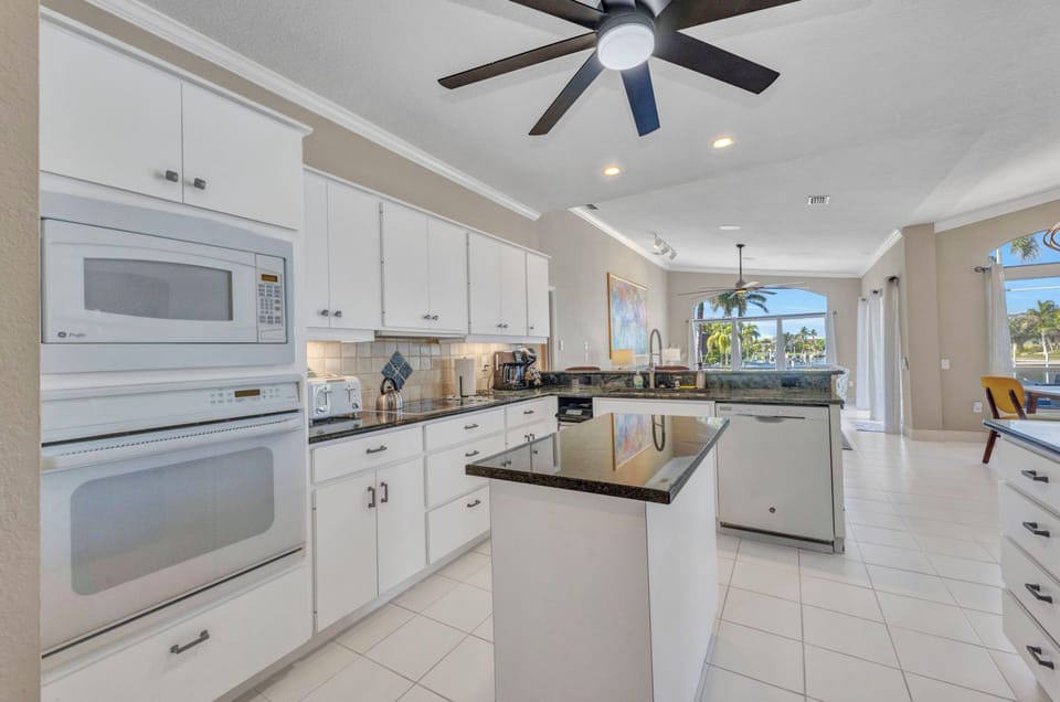 MODERN, OPEN KITCHEN WITH ENDLESS GRANITE TOPS.