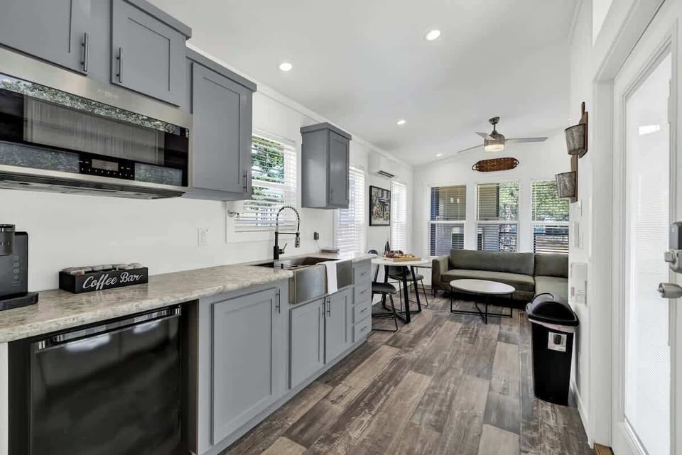 The cozy tiny home embodies warmth and comfort in its compact, inviting space.