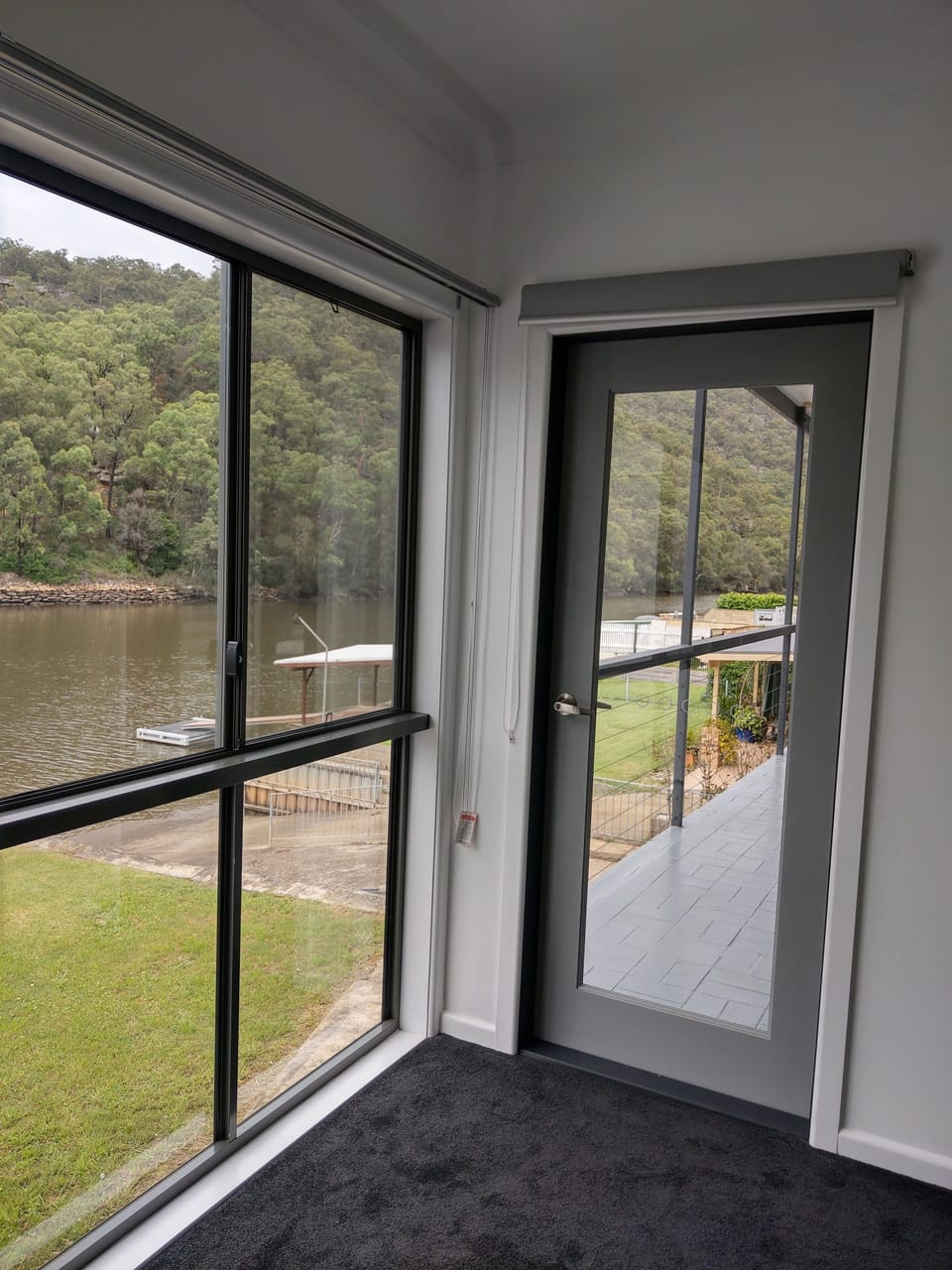 Bedroom 3 upstairs showing the vie over the river and access to the rear balcony