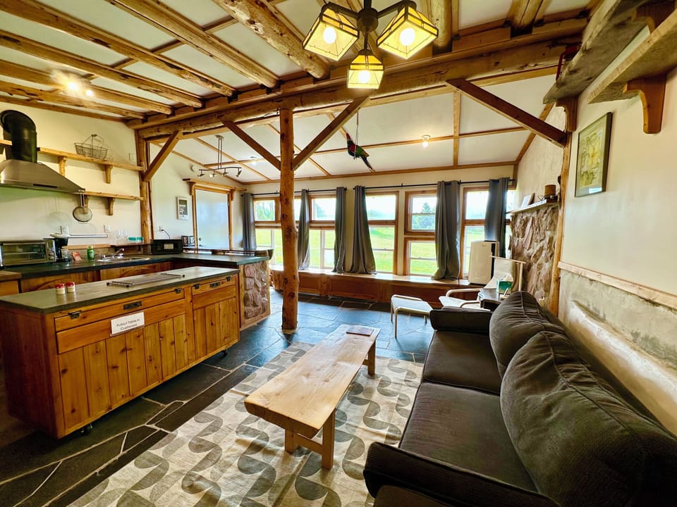 Kitchen sitting area, island stone on walls, and slate floors