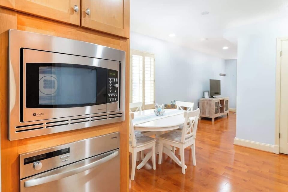 Located directly off the dining room, the updated kitchen features sleek, stainless tell appliances that bring a modern touch to the space.  The kitchen offers a convenient and stylish environment for your culinary endeavors. 