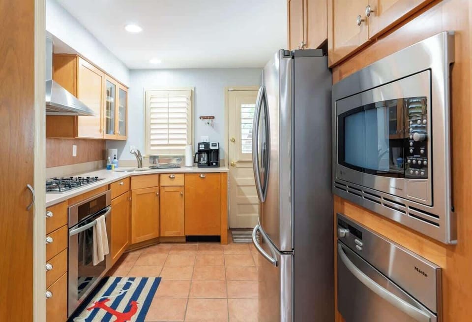 The updated kitchen features sleek, stainless tell appliances that bring a modern touch to the space.  The kitchen offers a convenient and stylish environment for your culinary endeavors. 