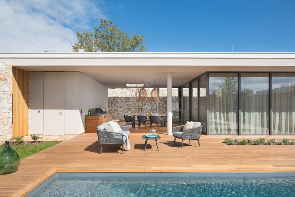 A spacious terrace with a sunbathing area for relaxing next to the large swimming pool of a private family villa  Serenity Pula for rent in Istria 