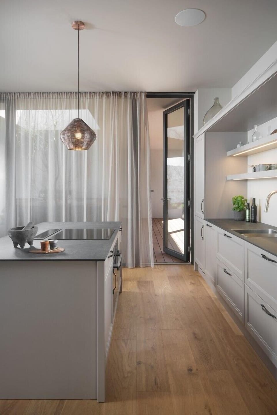 Interior of a modern air-conditioned kitchen, equipped with all appliances with an island and chairs in a private villa for rent Serenity Pula in Istria